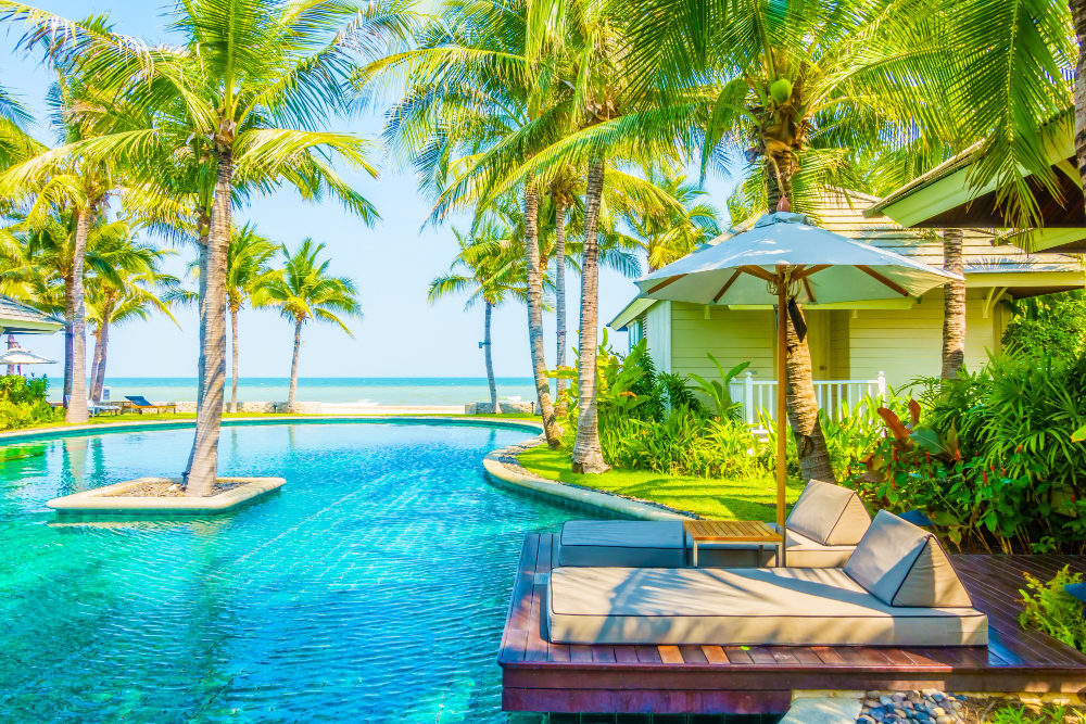 A private pool and lounge deck beside a resort-style home, the kind of luxury property 3A Allied Insurance protects with High Value Home Insurance.