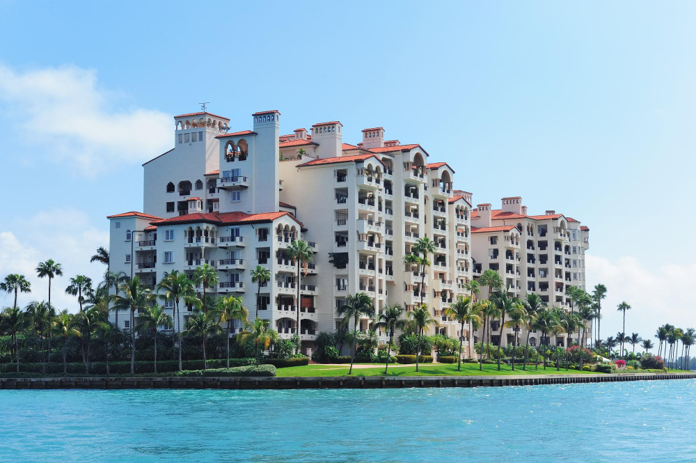 A Mediterranean-style waterfront condo building, the investment property 3A Allied Insurance covers under Real Estate Investor Insurance Florida.