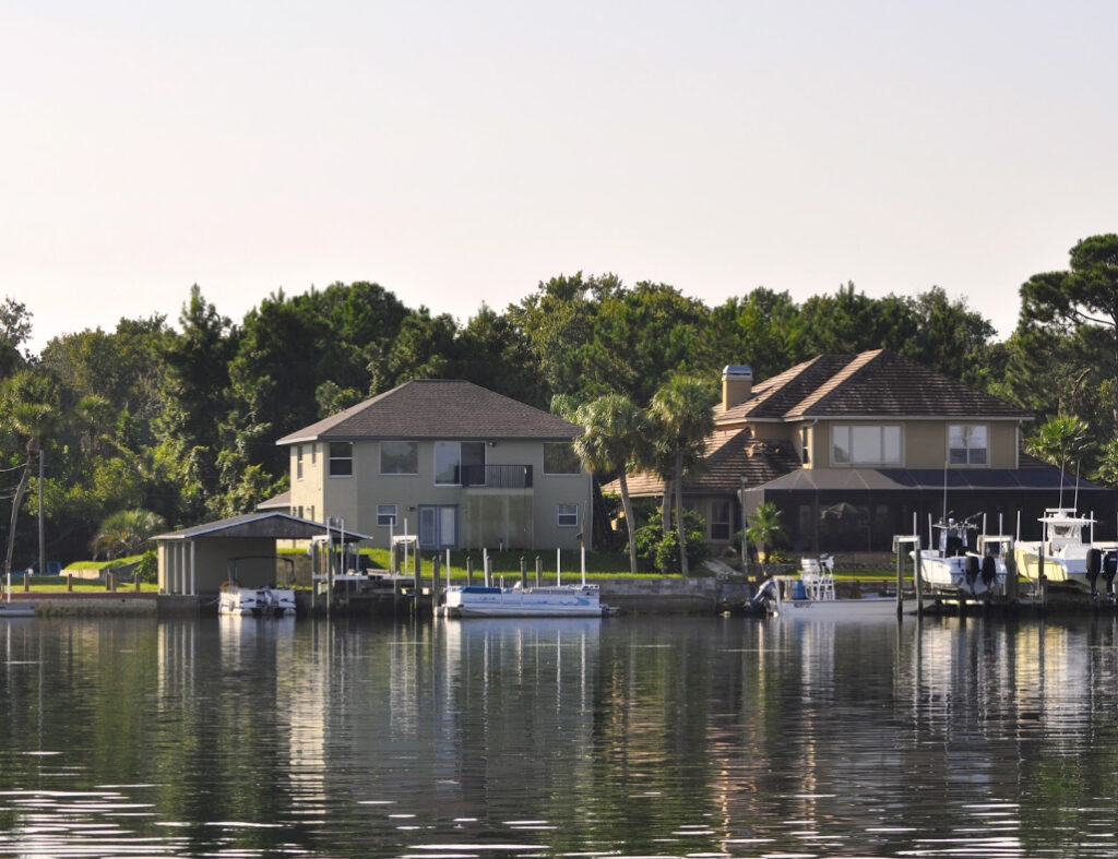 Citrus County Insurance coverage area image of waterfront homes with boat docks along a calm waterway on Florida's Nature Coast.