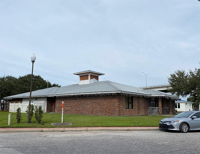 A brick building with a metal roof and cupola on a Glades County street, the type of property 3A Allied Insurance protects with Glades County Insurance.