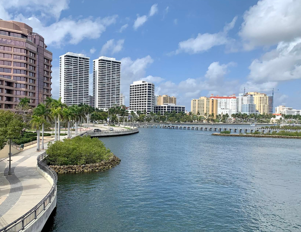 Palm Beach County waterfront high-rises along a curved walkway and canal, the coastal homes 3A Allied Insurance protects with Palm Beach County Insurance.