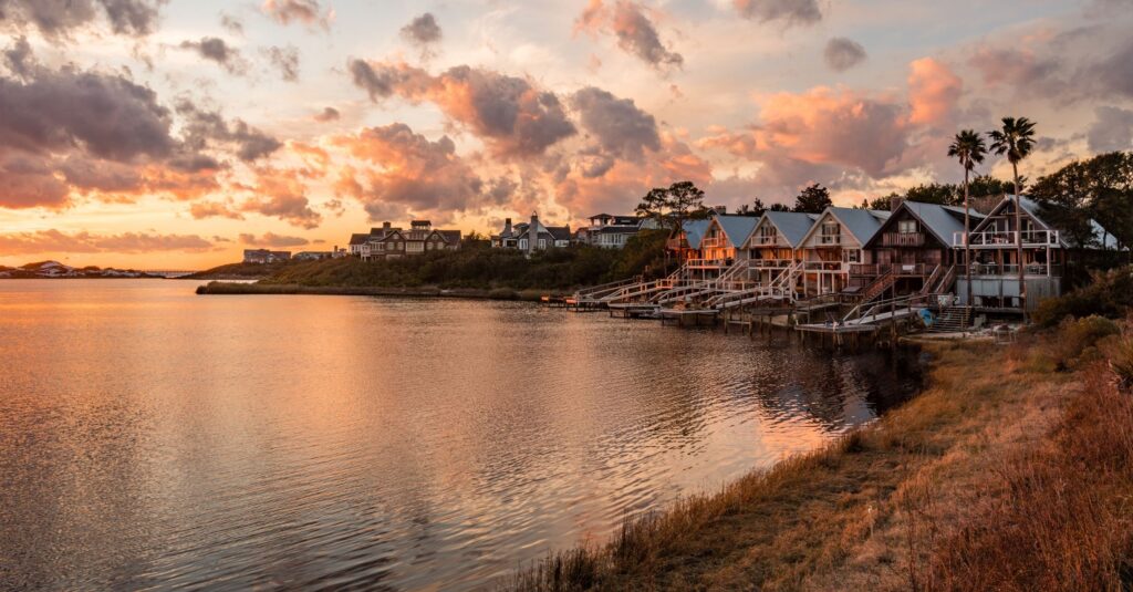 Waterfront beach homes along a coastal inlet at sunset in Walton County, the 30A property 3A Allied Insurance protects with Walton County Insurance.